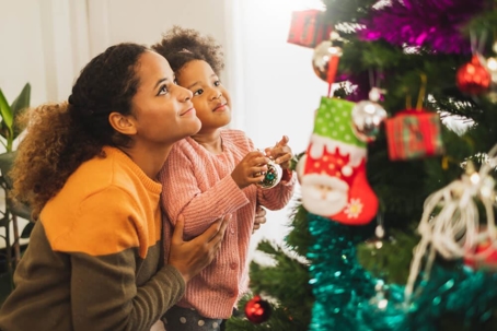 Parent and child decorating Christmas tree